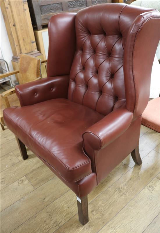 A button back leather wing armchair